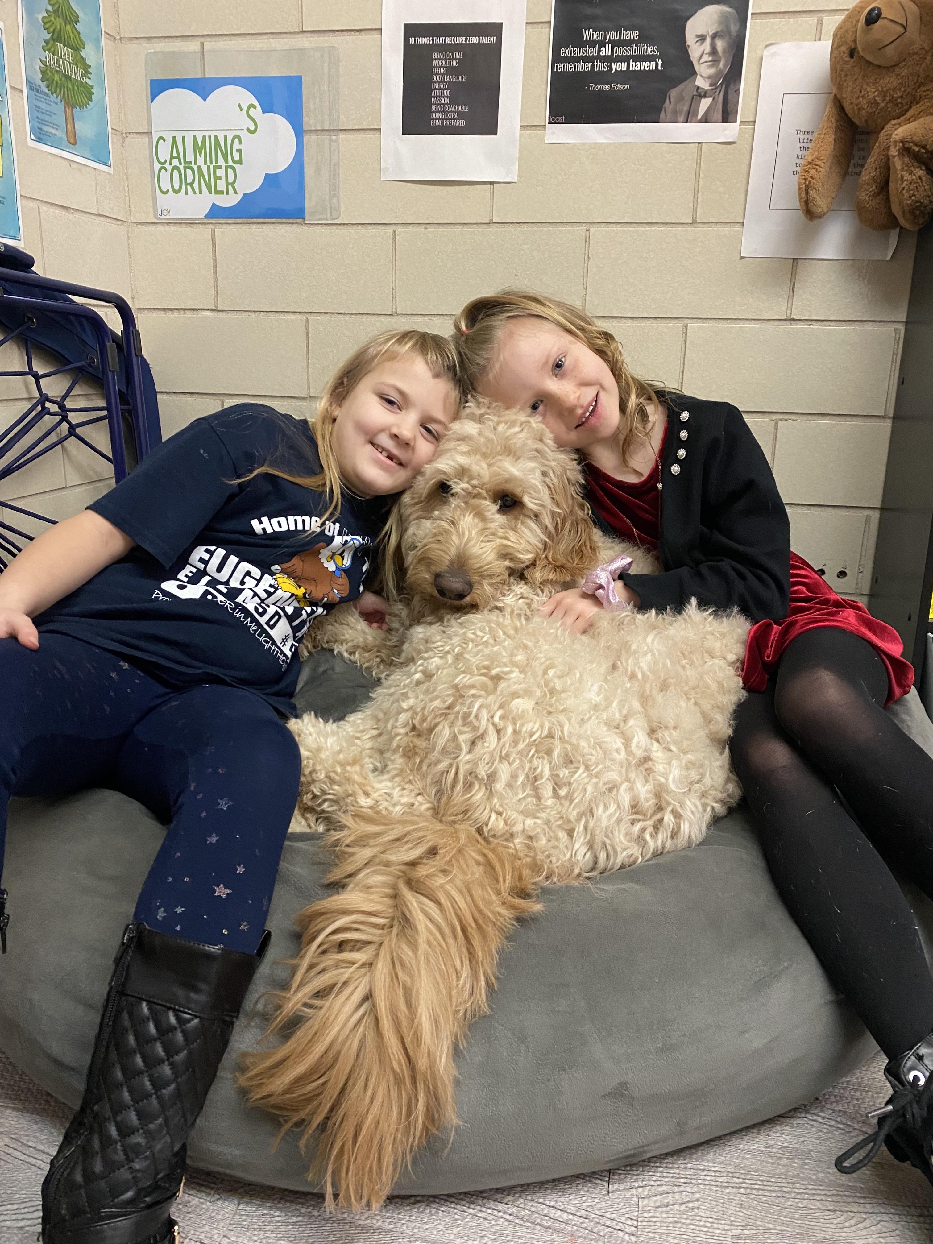 students cuddling with Sam the dog